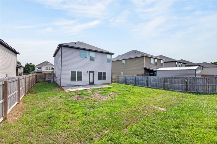 A spacious backyard awaits, complete with a private fence and a practical shed for extra storage.