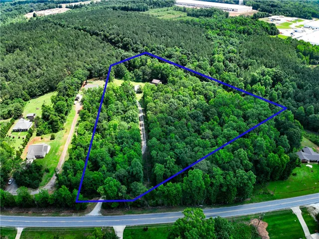 Vast, verdant acreage offers privacy and a serene natural setting, perfect for your dream estate.