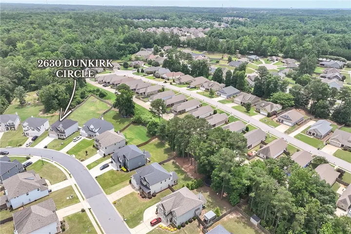 An aerial perspective showcases a vibrant neighborhood, offering a glimpse of residential living.