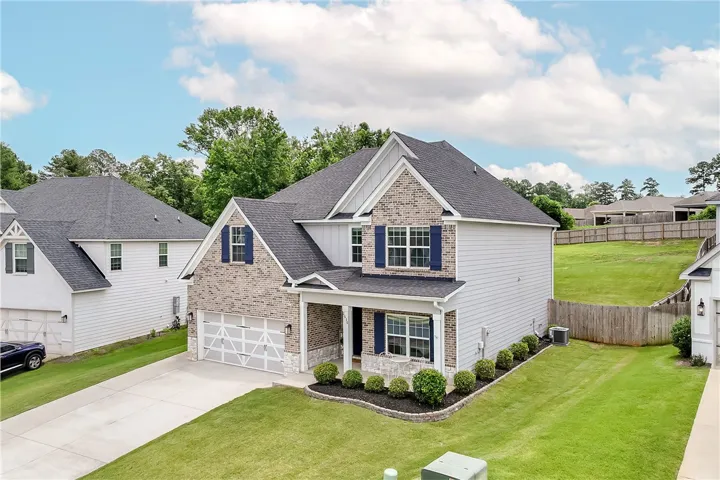 A classic two-story home, with an attached garage, offers inviting curb appeal.