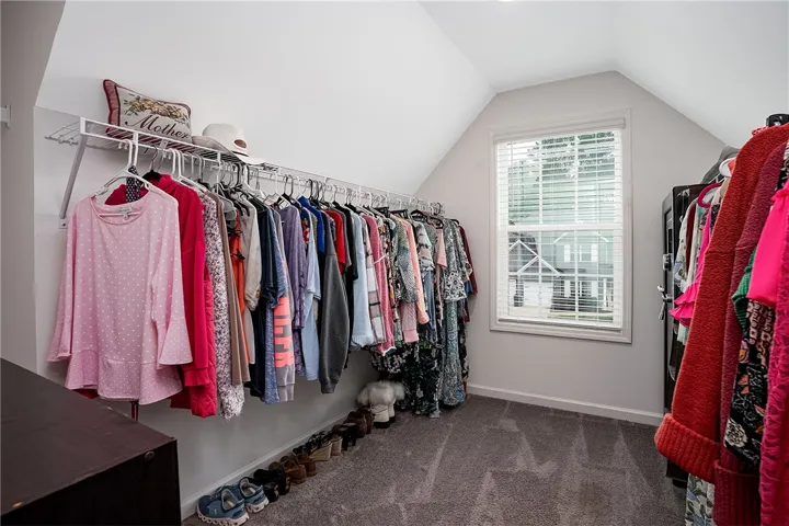 A well-organized closet offers ample space for storage with convenient built-in shelving.
