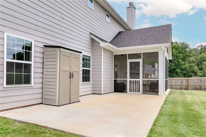 A spacious backyard patio with a screened porch for comfortable outdoor living.