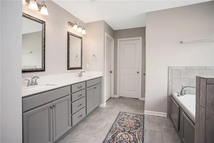 Dual vanities with ample counter space create a functional bathroom.