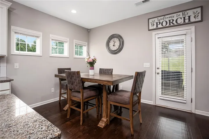 Granite counters complement the rich hardwood flooring in this cozy dining area.