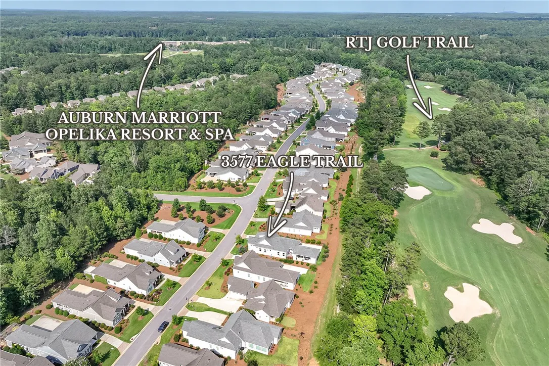 An aerial perspective reveals a vibrant neighborhood with golf course access and nearby resort amenities.