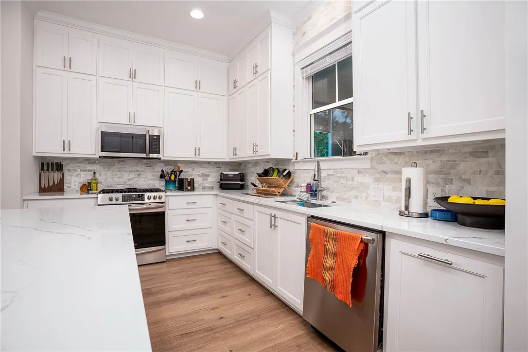 Culinary delights await in this bright, well-appointed kitchen featuring sleek appliances and generous counter space.