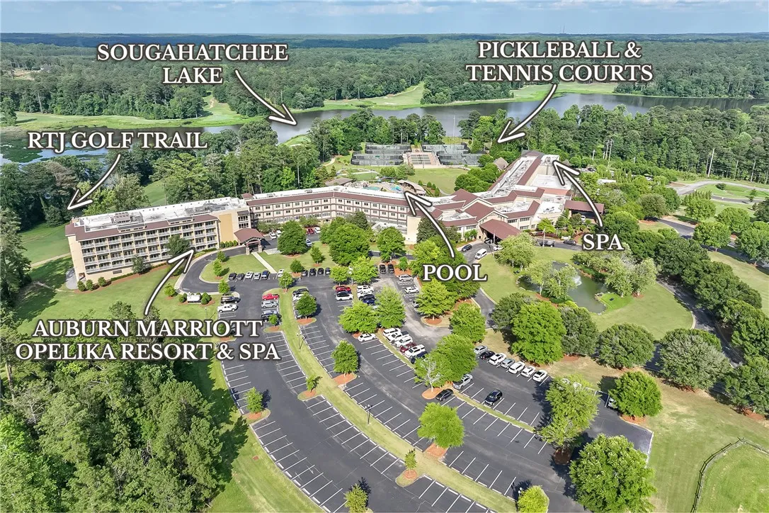 An aerial panorama reveals a resort haven with a lake, golf course, and recreational amenities.