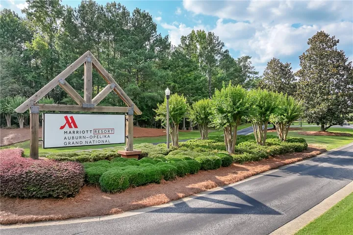 Manicured landscaping surrounds this welcoming entrance, hinting at the quality within.