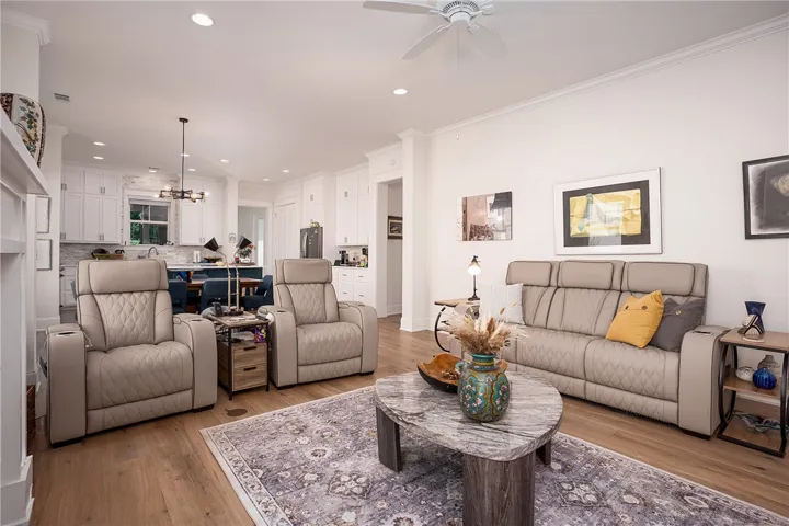 An open concept living area seamlessly flows into a well-appointed kitchen, creating an inviting space for gathering.