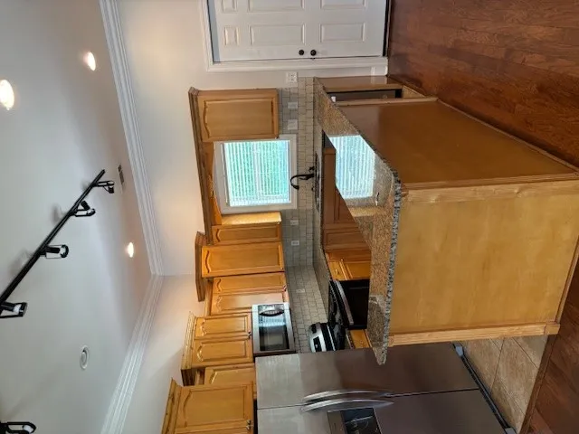 A well-equipped culinary space awaits with rich cabinetry and durable countertops.