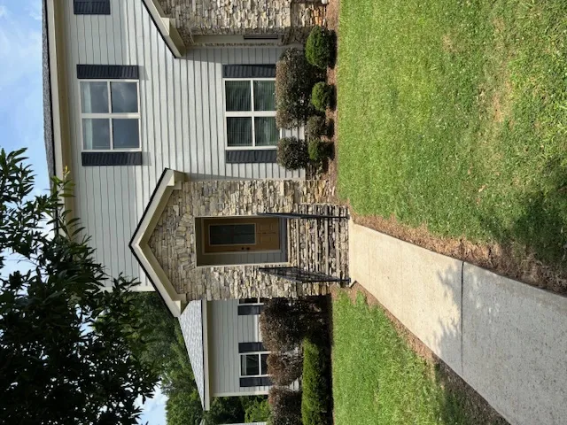 Stone facade and siding provide attractive curb appeal to this inviting residence.