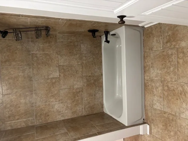 A well-appointed bathroom featuring a clean bathtub and tile surround.