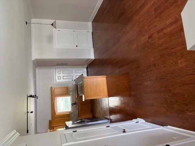 Refined wood floors complement this well-appointed kitchen and dining area.
