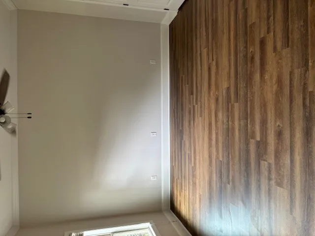 Rich wood plank flooring sets the foundation for an inviting and versatile interior space.
