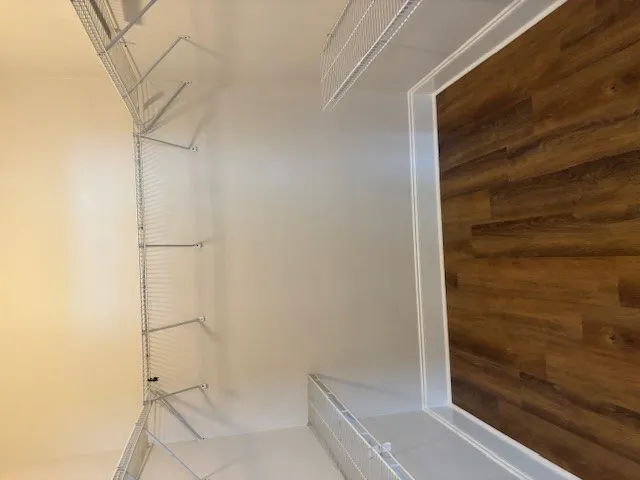 Streamlined wire shelving provides ample storage in this well-appointed closet.