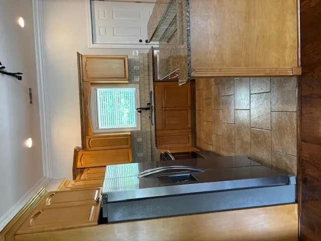 Stainless steel appliances and rich wood cabinetry define this kitchen's appealing aesthetic.