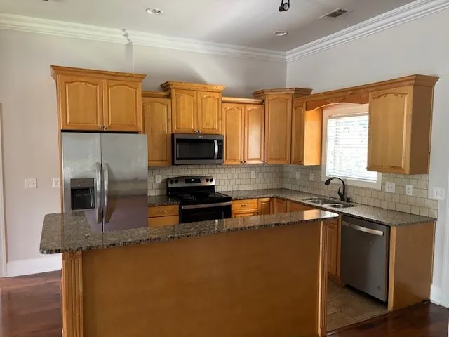 Granite counters and stainless steel appliances adorn this efficient culinary space.