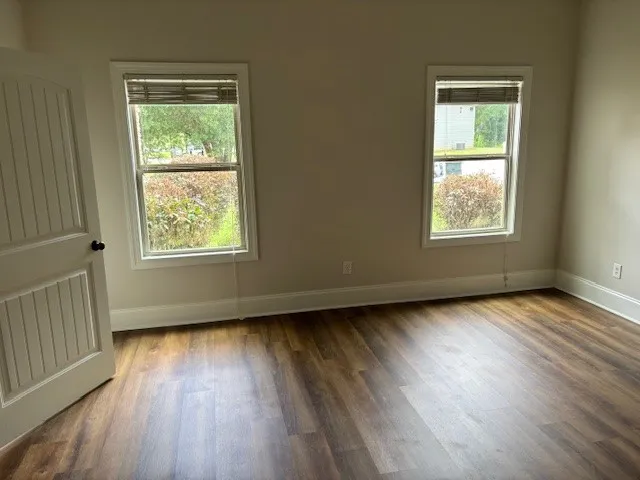 Rich wood plank flooring sets a warm tone in this inviting space.