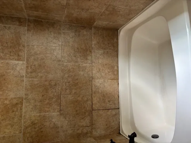 Indulge in relaxation with a spacious bathtub and durable tile surround.