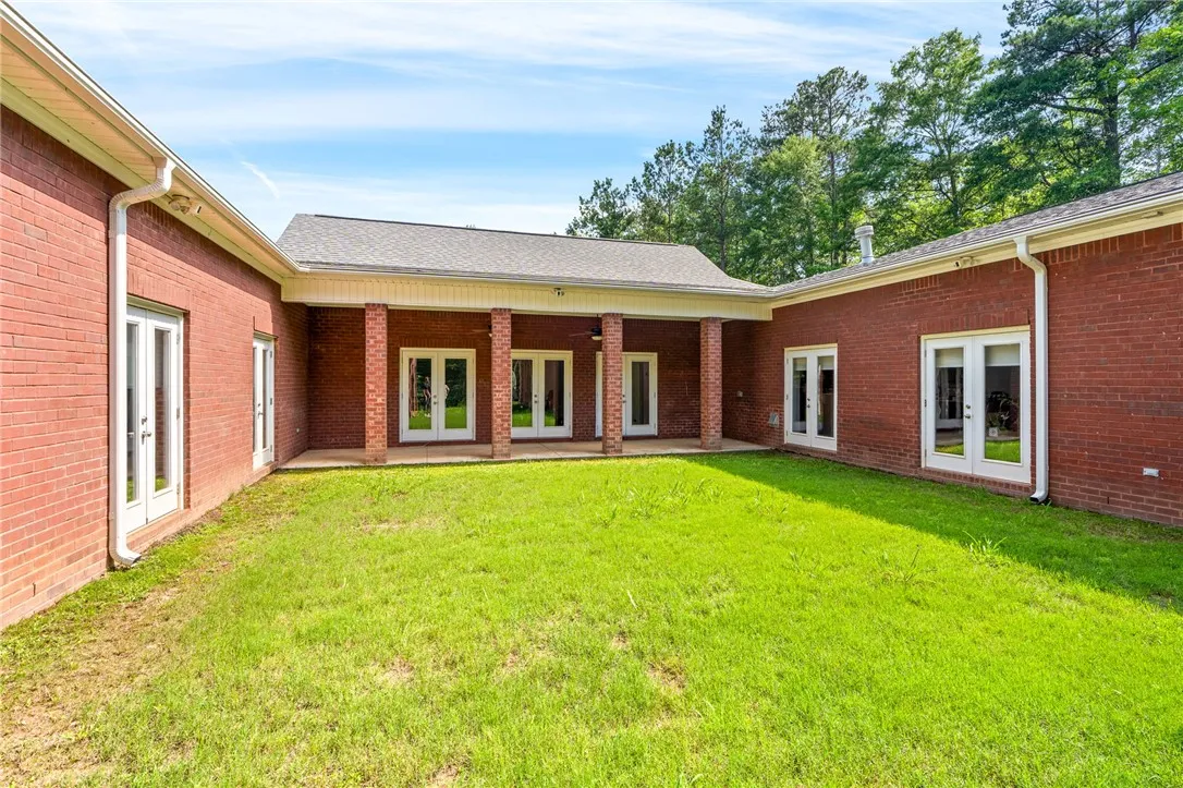 A spacious backyard with a covered patio, perfect for outdoor living and entertaining.