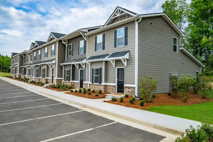 Contemporary multi-family residences boast inviting facades and manicured landscaping.
