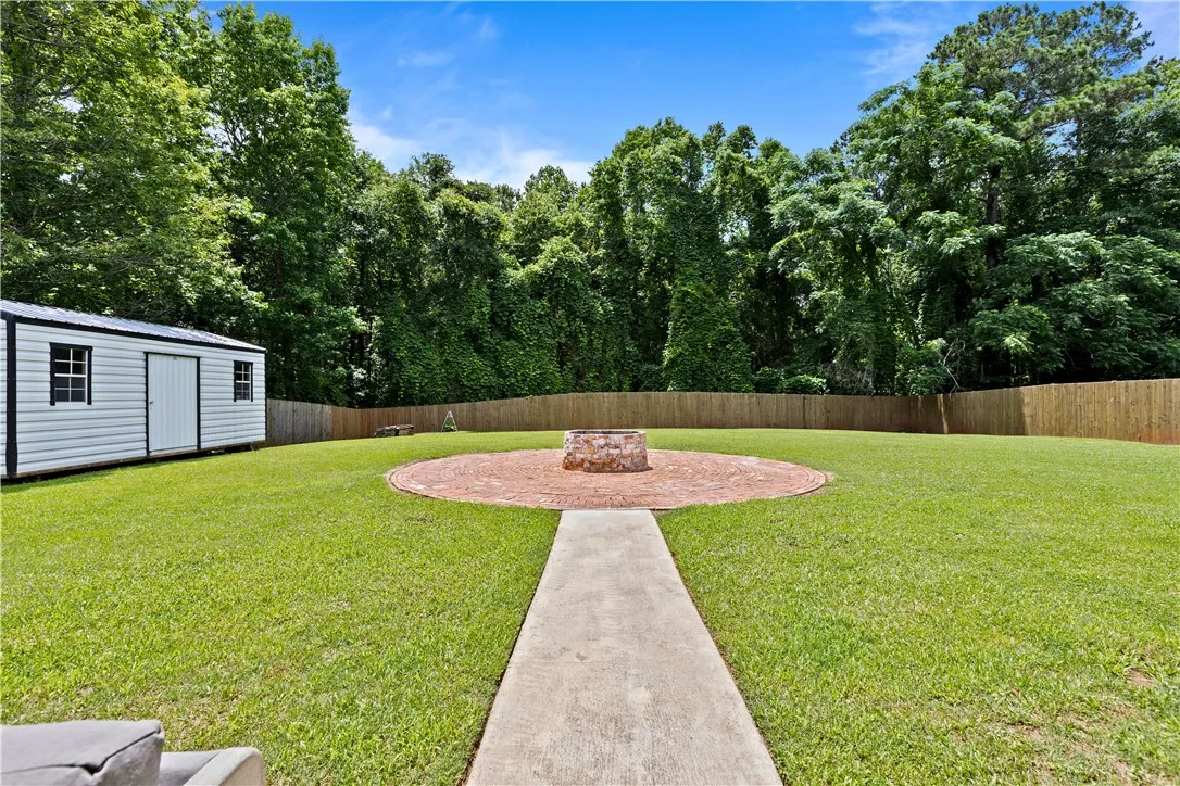 A generous lawn with a charming fire pit patio, perfect for outdoor gatherings.