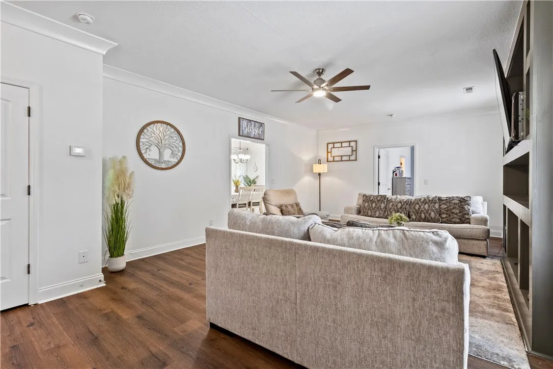 Rich hardwood floors complement this spacious living area, ideal for relaxed gatherings.