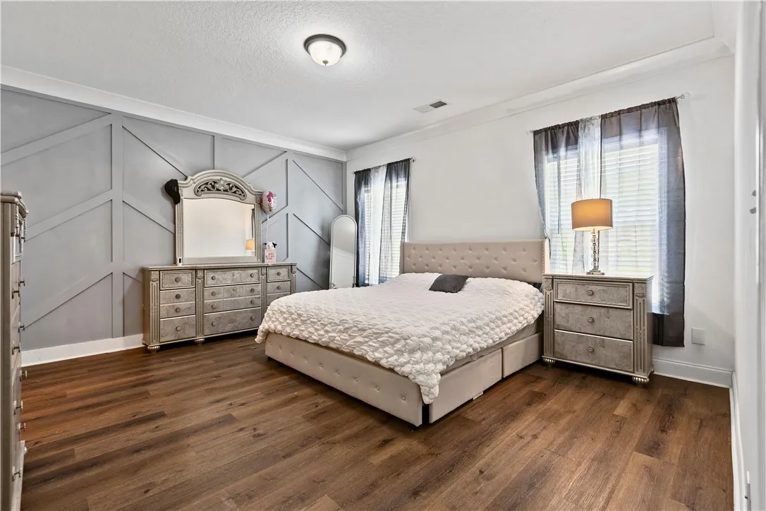 Rich LVP floors complement a custom feature wall in the main.