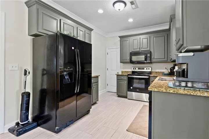 Granite counters and stainless steel appliances adorn this well-appointed kitchen.