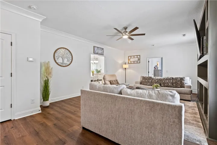 Rich hardwood floors complement this spacious living area, ideal for relaxed gatherings.