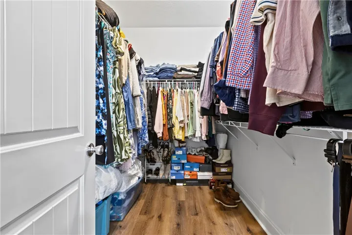 Streamlined organization awaits in this ample walk-in closet with durable flooring.