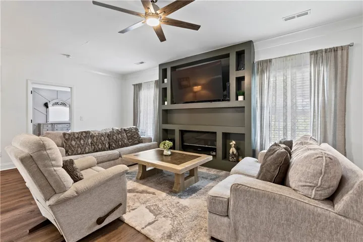 An inviting family room showcasing a contemporary custom media built-in and stylish window treatments.