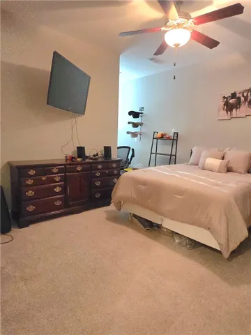 Comfortable bedroom featuring vaulted ceilings and soft carpeting, perfect for peaceful repose.