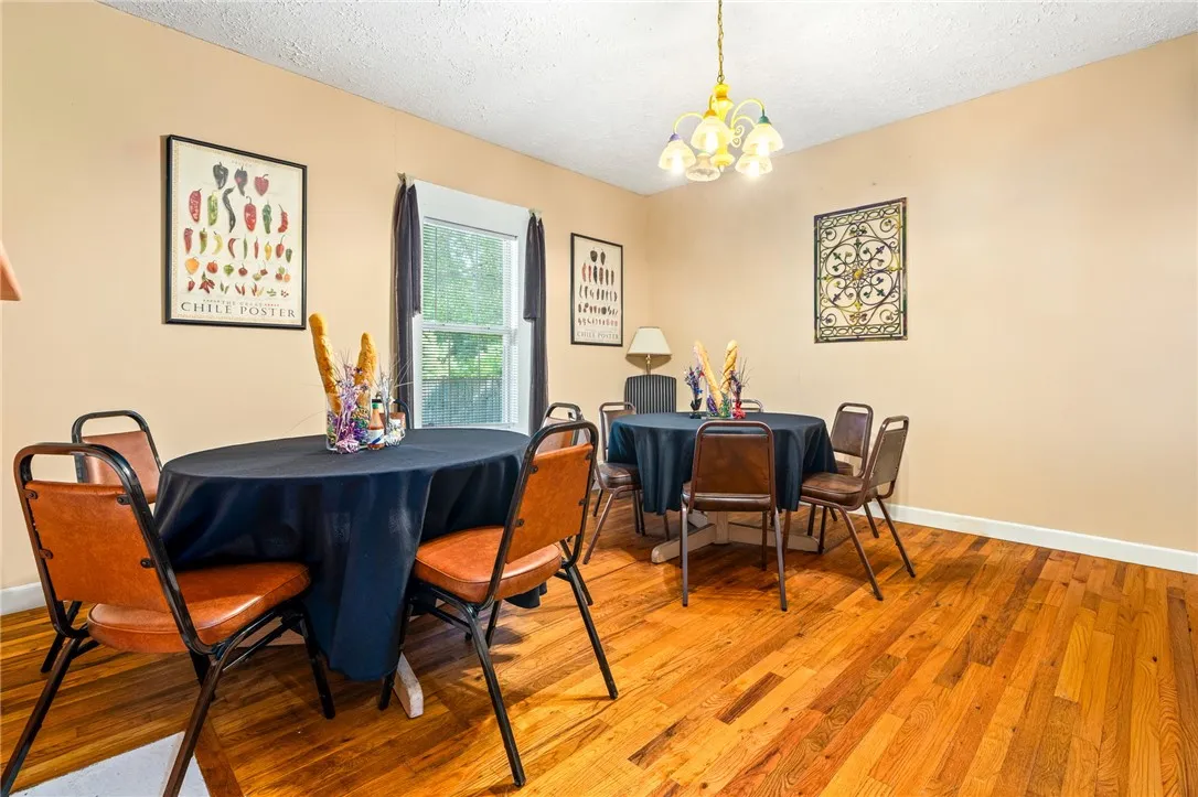 Rich hardwood floors complement the neutral walls and provide a warm setting for dining.
