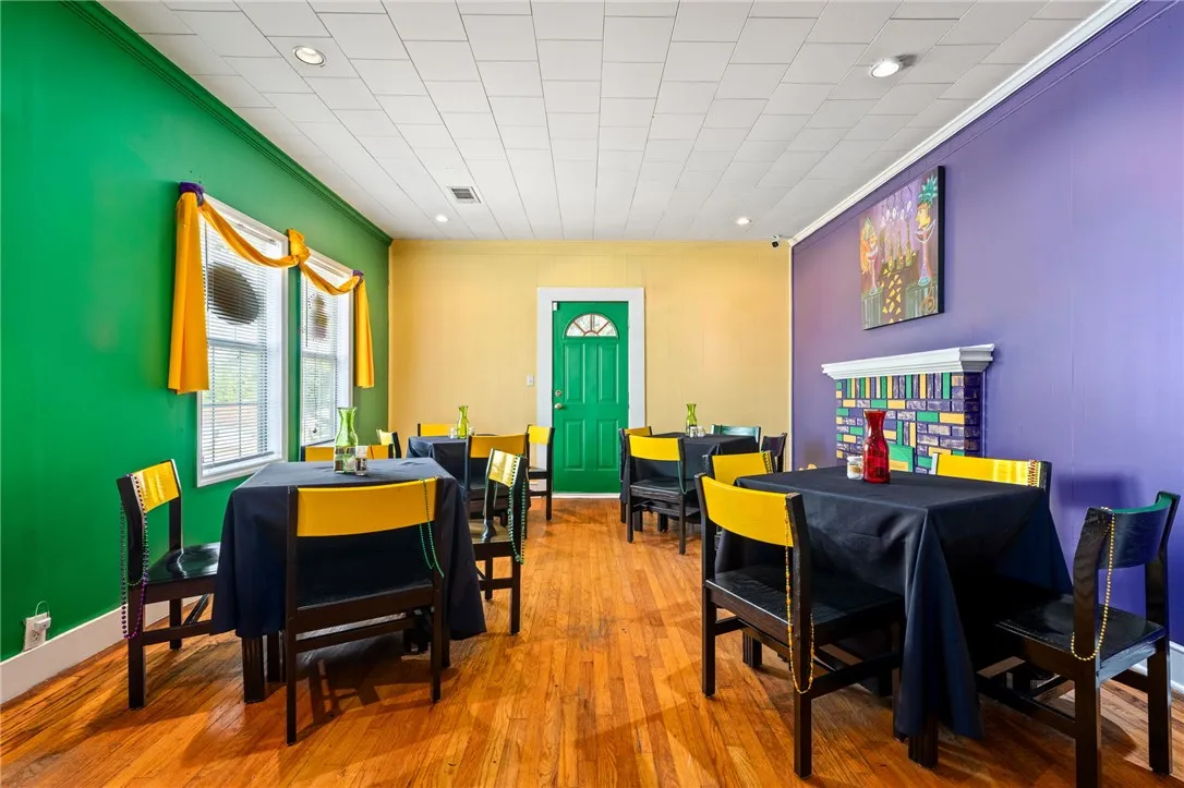 Hardwood floors and bright, multi-hued walls define this lively dining space, ready for your next event.
