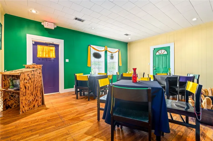 Hardwood floors and vivid walls create a lively ambiance in this welcoming dining area.