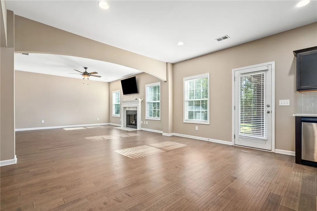 Hardwood floors and a cozy fireplace define this open-concept living space.