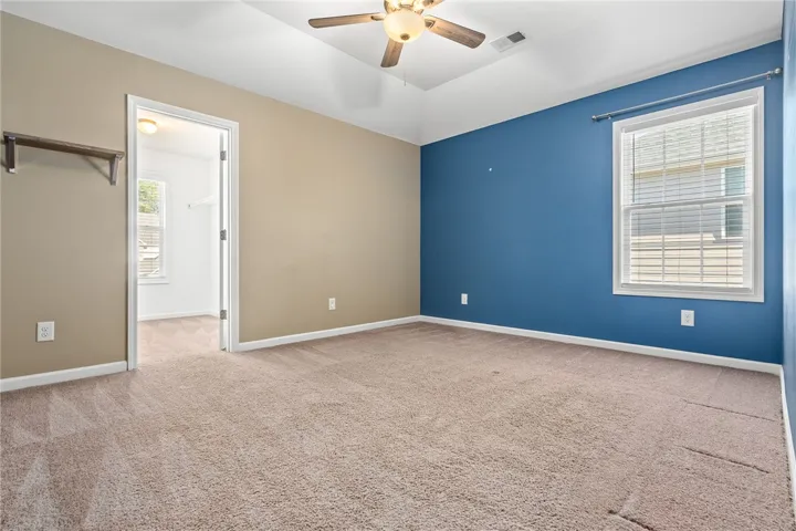 A quiet retreat, this bedroom offers plush carpet and a convenient walk-in closet.