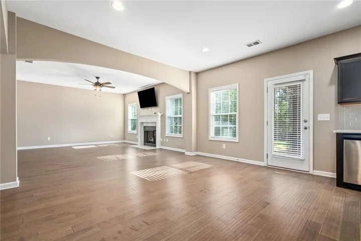 Hardwood floors and a cozy fireplace define this open-concept living space.
