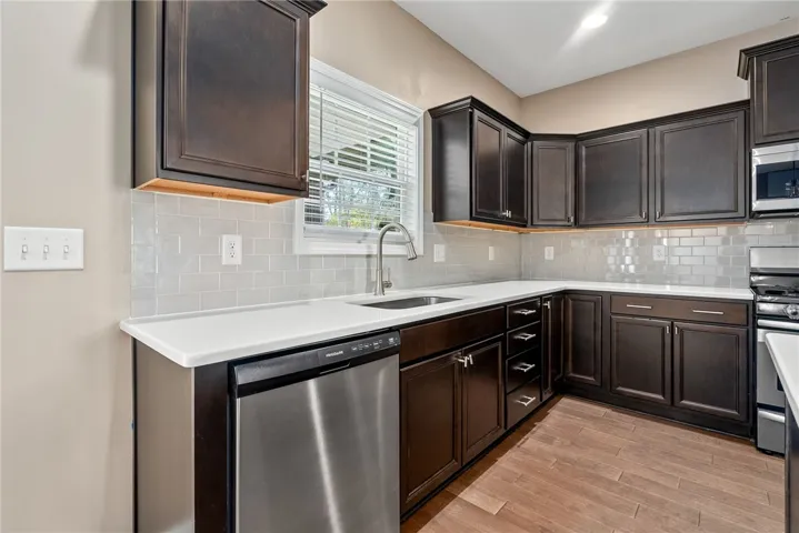 A well-appointed kitchen showcasing elegant cabinetry and light-toned countertops.