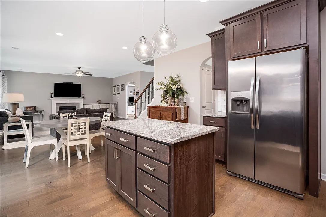 A stylish kitchen island with granite counters anchors this open-concept living space.