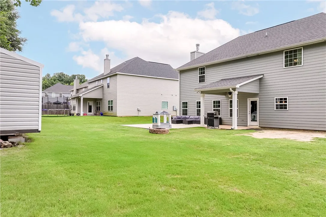 A spacious backyard with an inviting patio offers ample room for outdoor activities and relaxation.