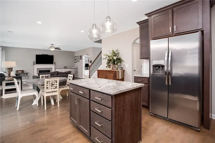 A stylish kitchen island with granite counters anchors this open-concept living space.