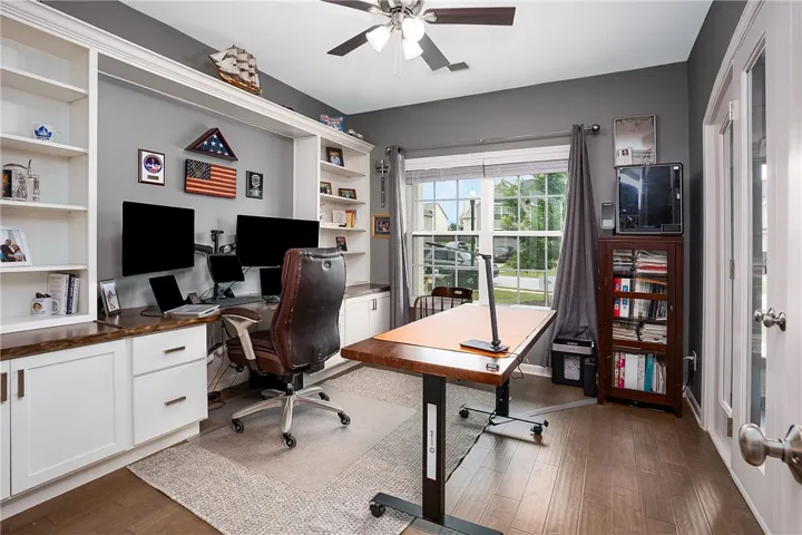 Built-in shelving and ample desk space create a dedicated workspace for productivity and organization.