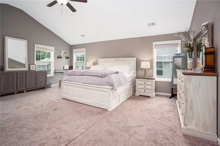 Relax in this well-appointed sleeping area with a vaulted ceiling and soft carpeting.