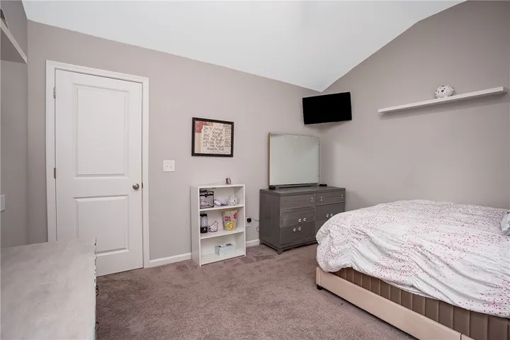 Cozy bedroom with vaulted ceilings offers a quiet retreat for rest and relaxation.