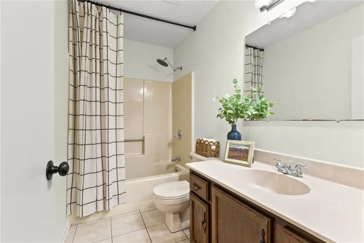 Hall bathroom featuring a clean tub-shower combination and a spacious vanity.