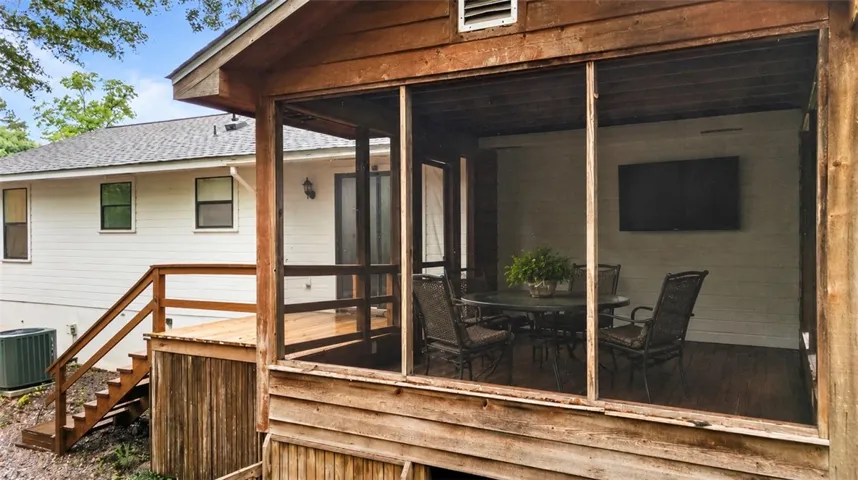Screened porch provides an inviting outdoor living space.  Storage underneath!