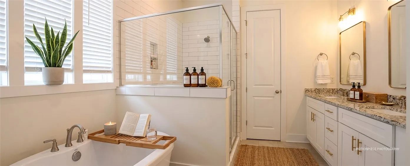 Indulge in a tranquil bathing experience in this well-appointed bathroom with a dual vanity.
