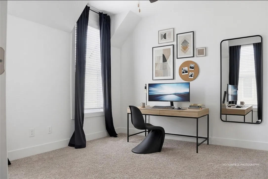 A well-lit, private study with soft carpeting creates an ideal space for focused work.